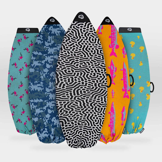 Five surfboard covers arranged in a fan shape against a light gray background. The covers feature different patterns and colors: teal with pink flamingos, blue digital camouflage, black and white zebra print, bright orange with pink fish, and teal with yellow ducks.
